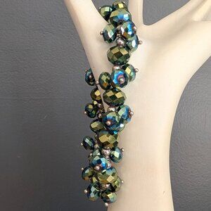 Faceted green beaded stretch bracelet with blue iridescence